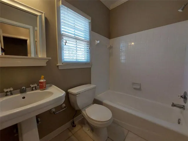 a bathroom with a sink toilet a mirror and bathtub