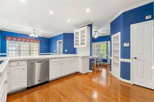 a large kitchen with stainless steel appliances granite countertop a large window and a refrigerator