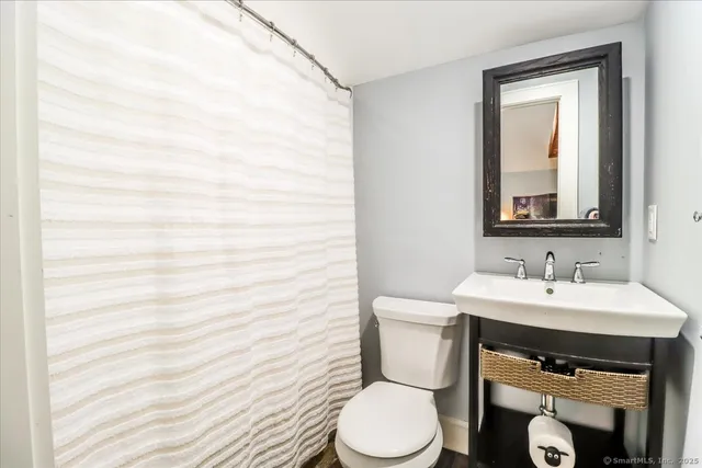 a view of a hallway with wooden floor and entryway