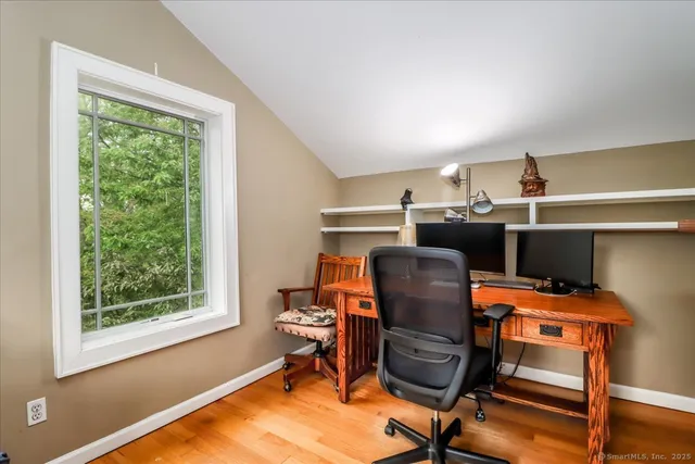 a blue bed sitting in a bedroom next to a larger window