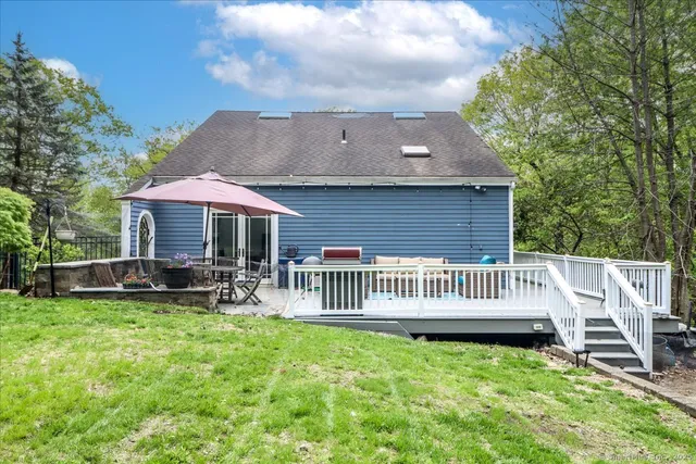 a view of a patio with furniture and a garden