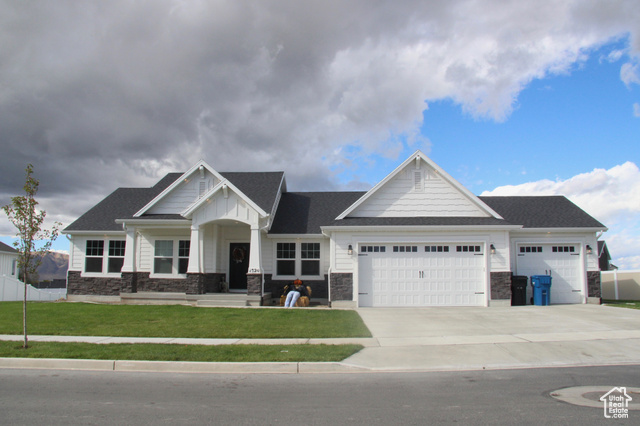 405 West 1200 North, Unit 4 Mapleton, UT 84664 - Photo 1 of 4 Craftsman house with an attached garage, driveway, a front yard, stone siding, and covered porch