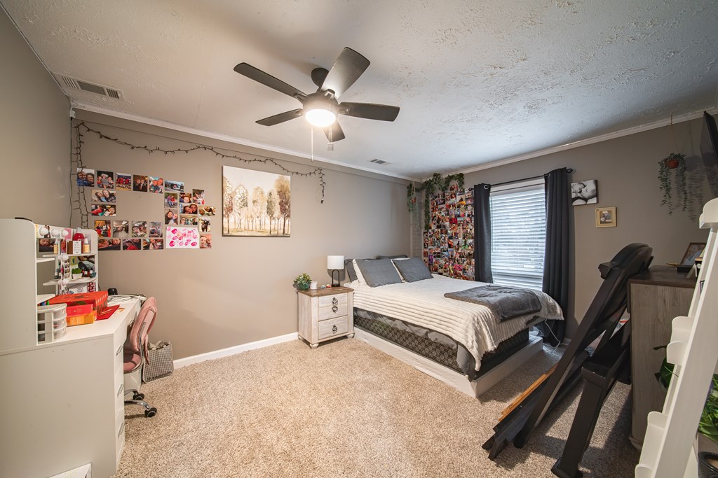 6315 Rockefeller Drive Columbus, GA 31909 - Photo 11 of 24 a bedroom with a bed wooden floor and window