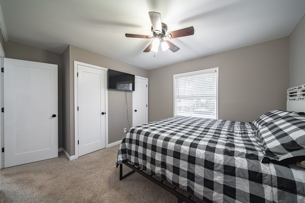 6315 Rockefeller Drive Columbus, GA 31909 - Photo 14 of 24 a bedroom with a bed and a chandelier
