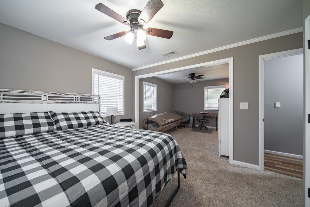 6315 Rockefeller Drive Columbus, GA 31909 - Photo 15 of 24 a bedroom with a large bed and a chandelier