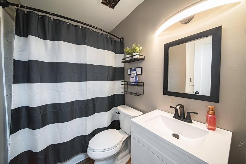 6315 Rockefeller Drive Columbus, GA 31909 - Photo 19 of 24 a bathroom with a sink a toilet and mirror