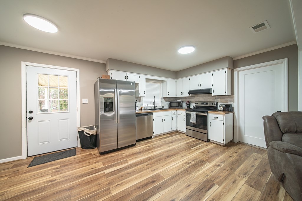 6315 Rockefeller Drive Columbus, GA 31909 - Photo 5 of 24 a kitchen with a refrigerator and cabinets