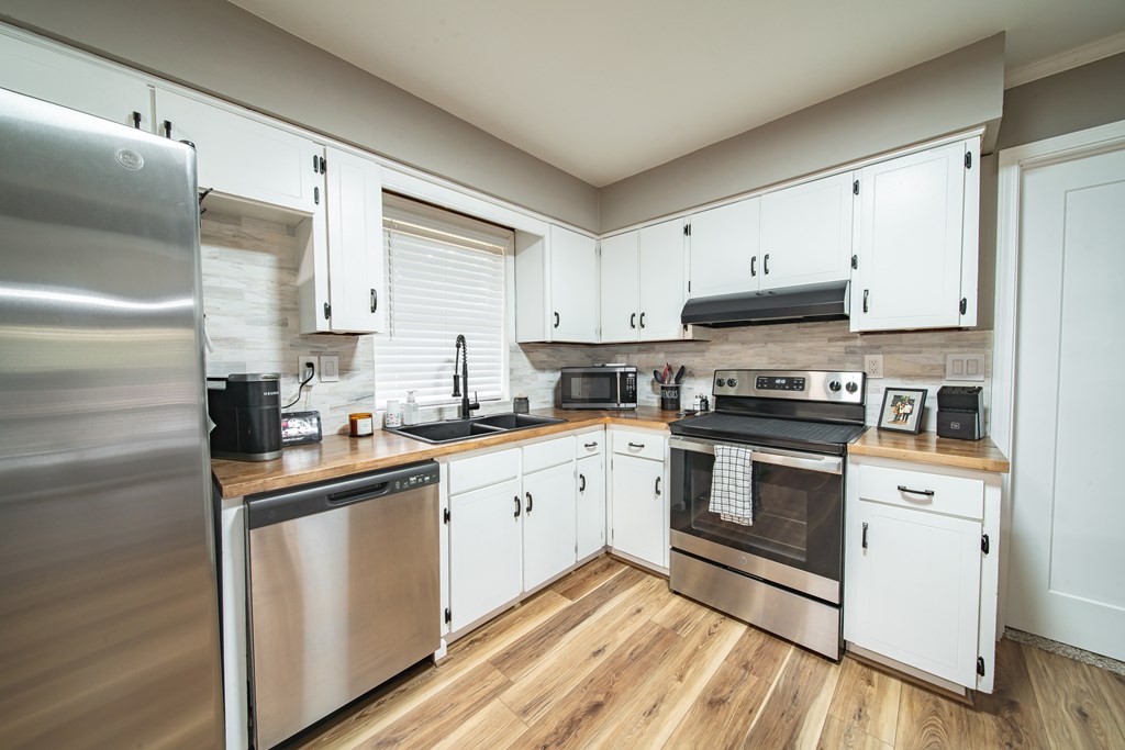 6315 Rockefeller Drive Columbus, GA 31909 - Photo 7 of 24 a kitchen with granite countertop cabinets stainless steel appliances and a sink