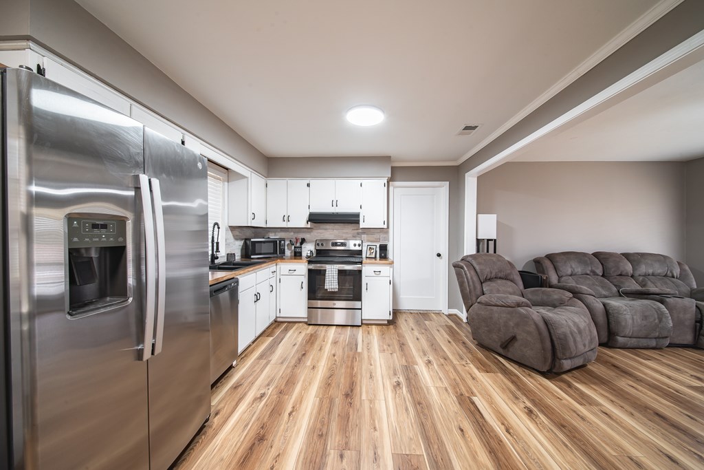 6315 Rockefeller Drive Columbus, GA 31909 - Photo 9 of 24 a large kitchen with stainless steel appliances granite countertop a refrigerator and a stove top oven