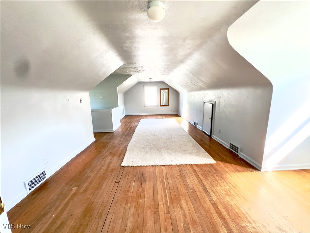 2024 Kirk Road Youngstown, OH 44511 - Photo 23 of 36 Additional living space featuring vaulted ceiling and hardwood / wood-style floors