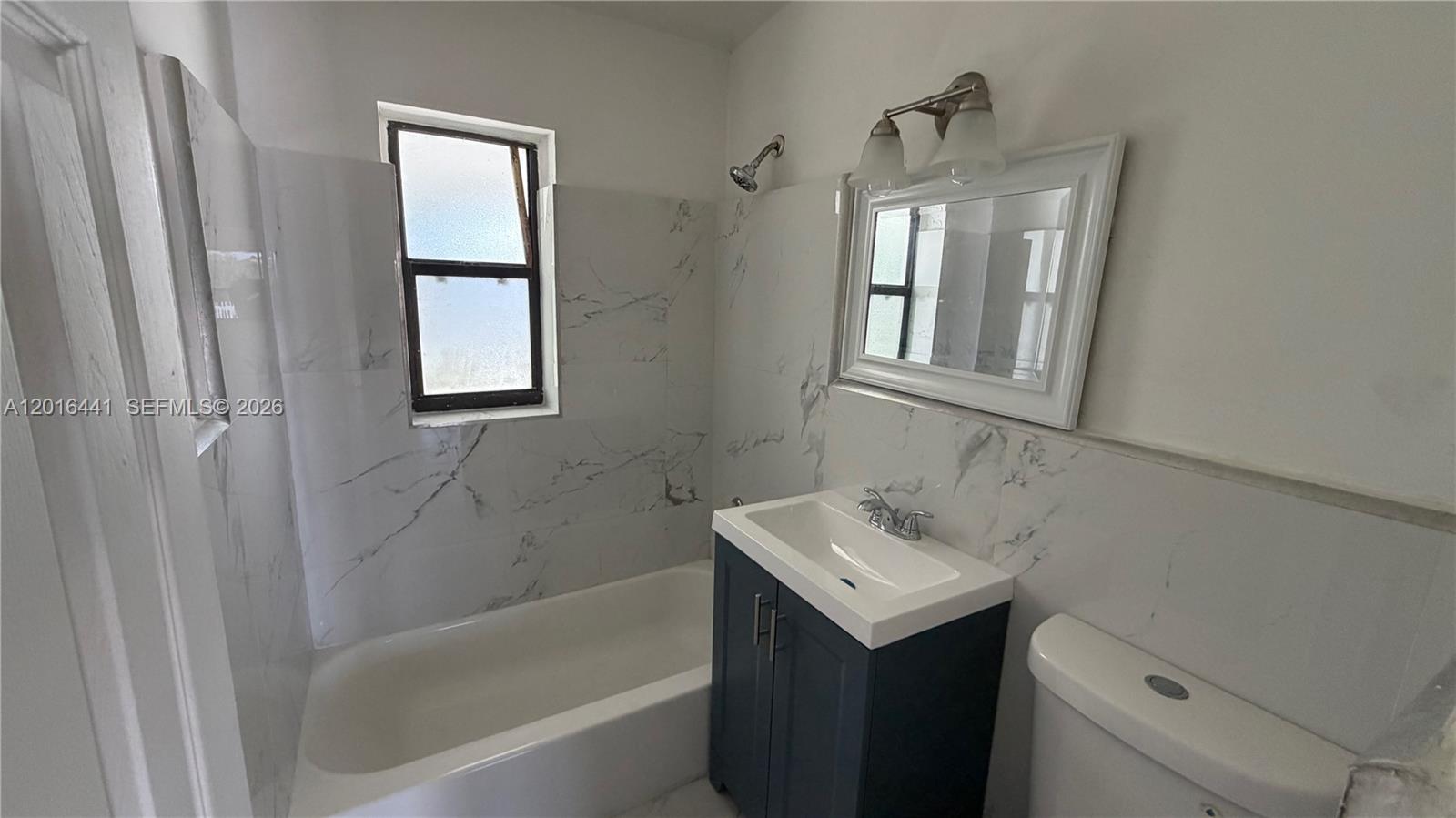 2230 Service Road Opa-Locka, FL 33054 - Photo 9 of 25 a bathroom with a sink toilet and shower