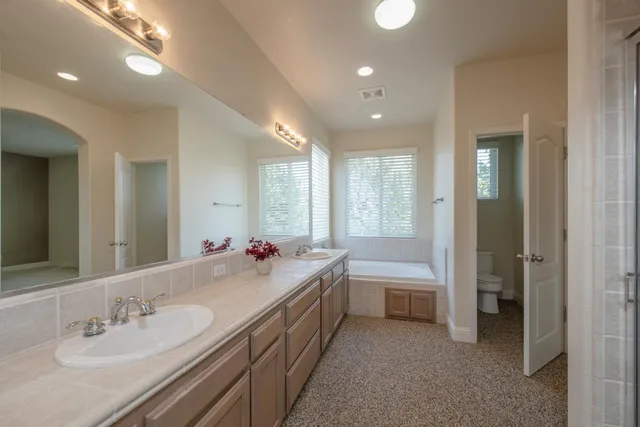 a bathroom with a double vanity sink mirror and double