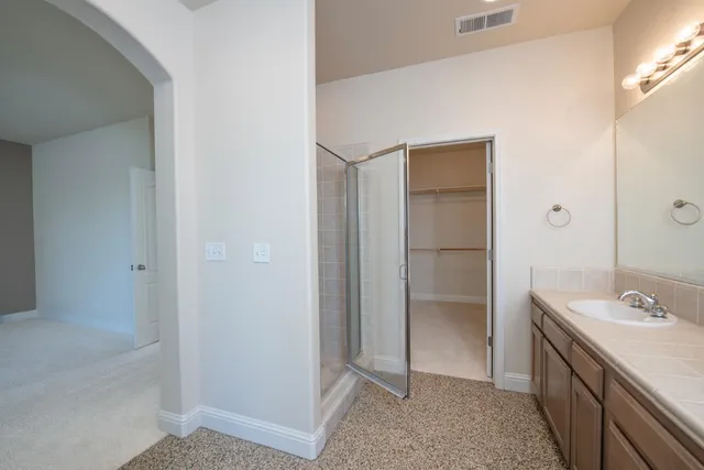 a view of hallway with bathroom