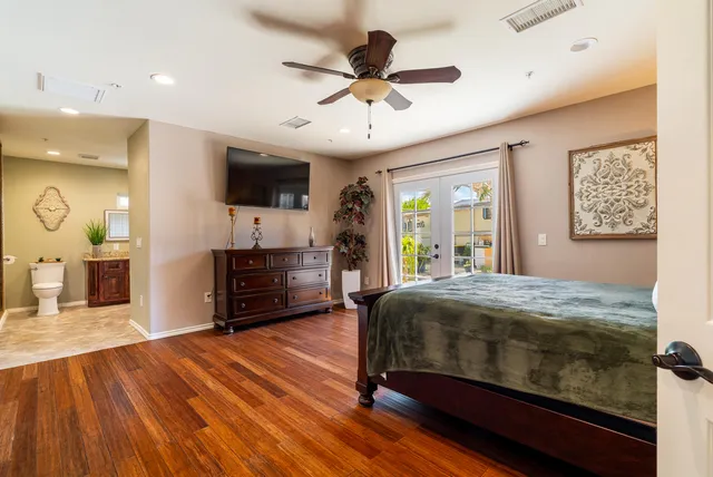 a bedroom with a bed and a flat screen tv