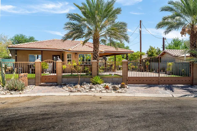 a front view of a house with garden and patio