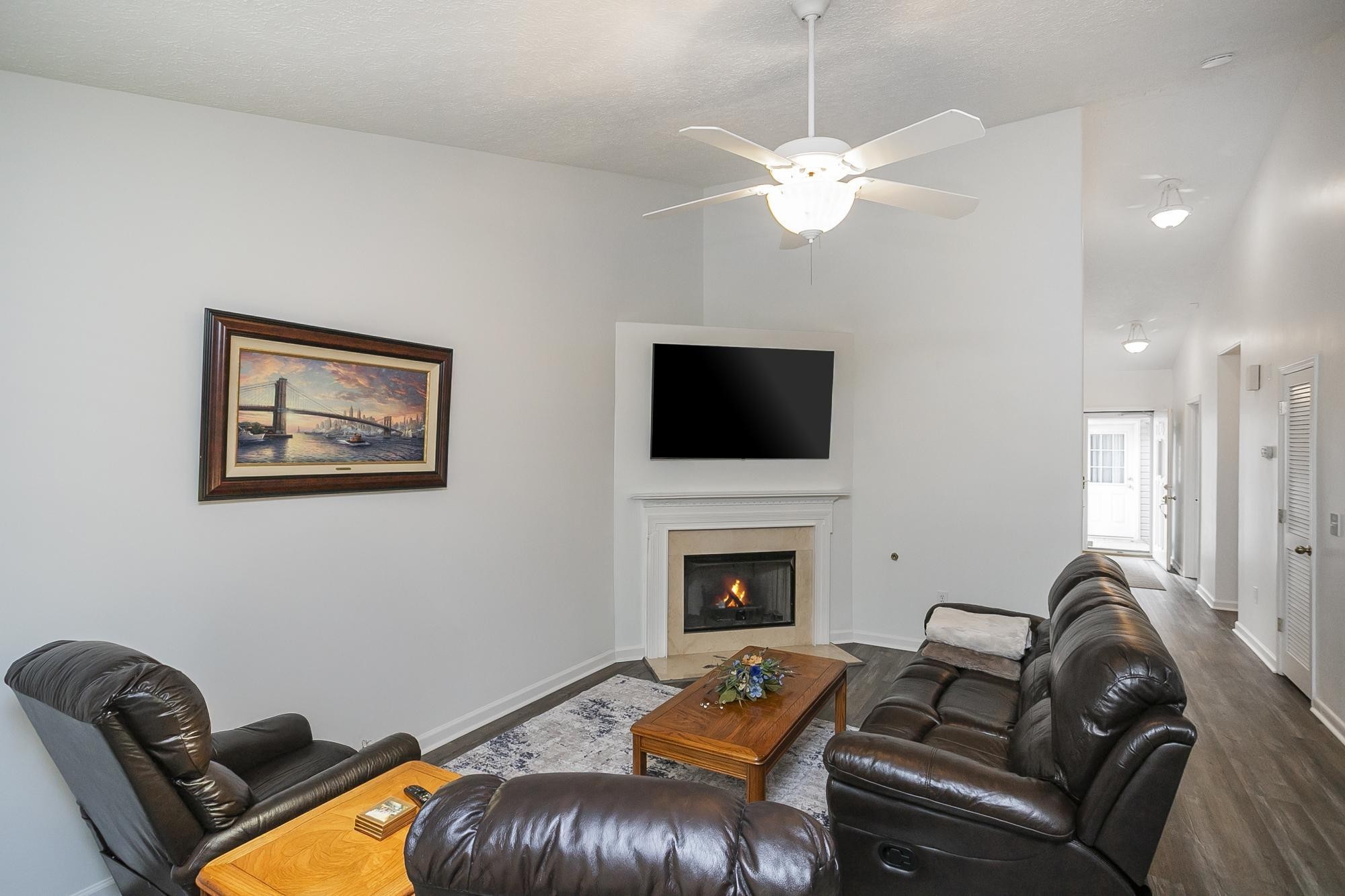3911 Dodson Chapel Road, Unit 32 Hermitage, TN 37076 - Photo 4 of 25 a living room with furniture a fireplace and a flat screen tv