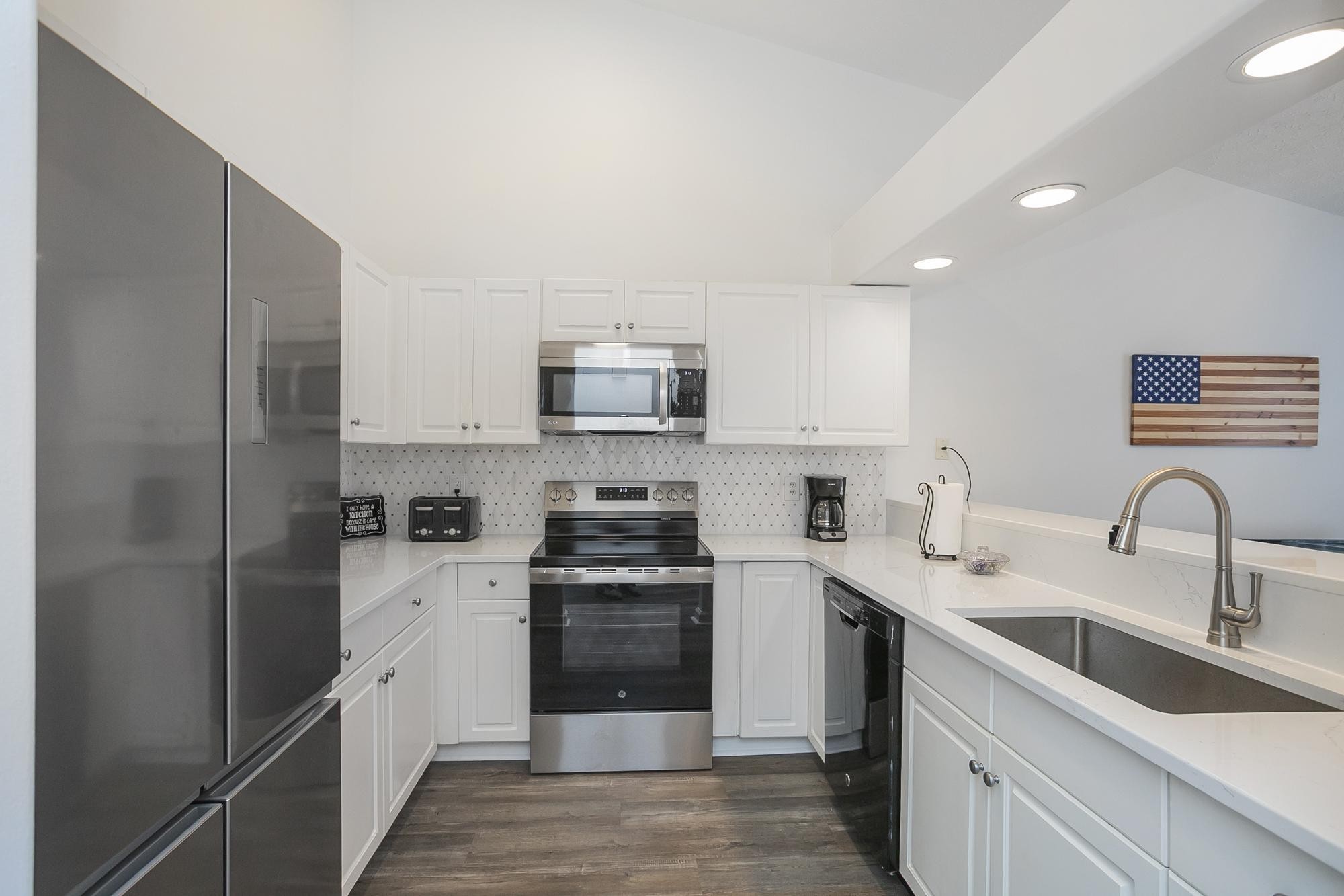 3911 Dodson Chapel Road, Unit 32 Hermitage, TN 37076 - Photo 6 of 25 a kitchen with stainless steel appliances granite countertop a sink stove and refrigerator