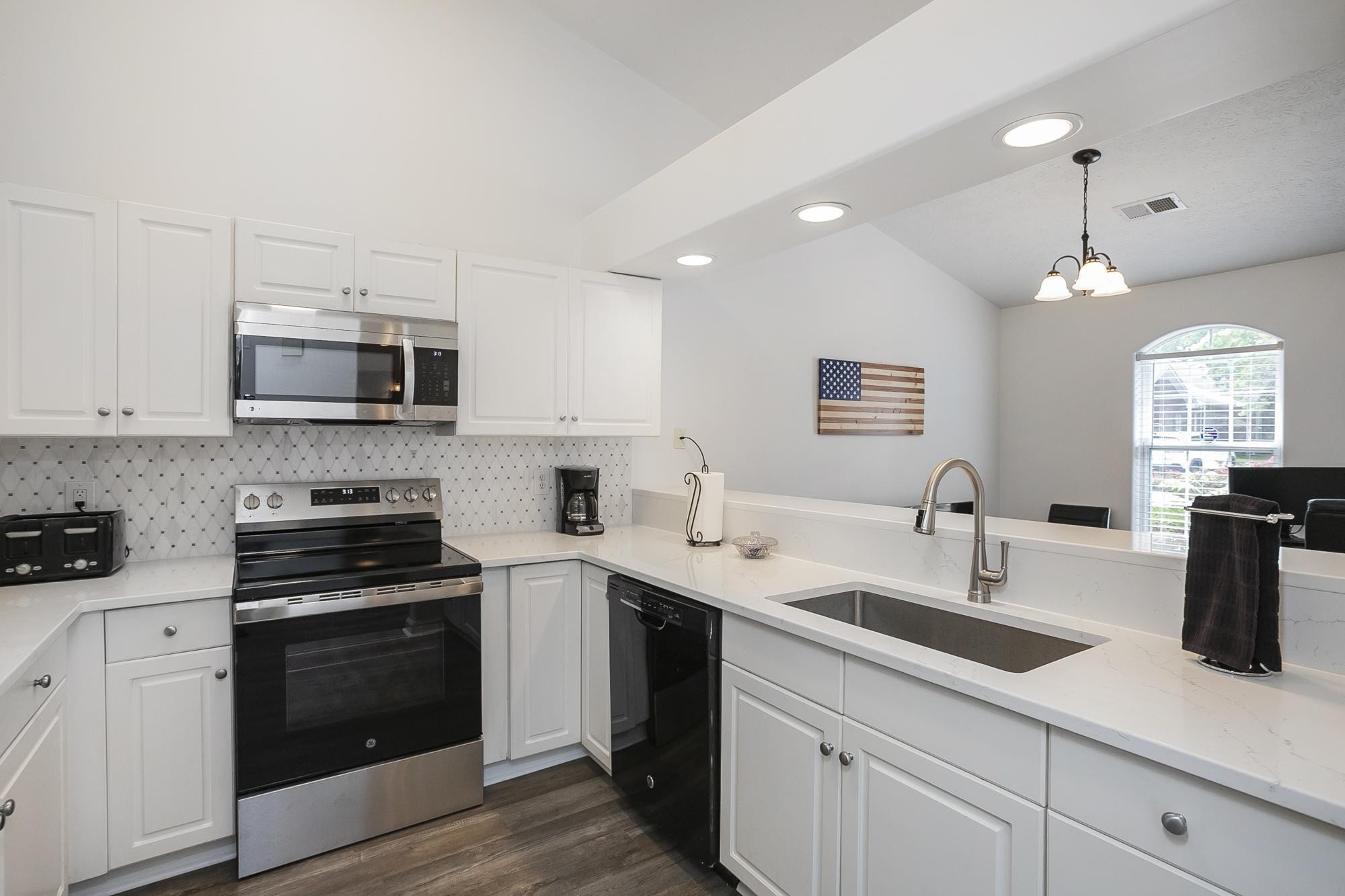 3911 Dodson Chapel Road, Unit 32 Hermitage, TN 37076 - Photo 7 of 25 a kitchen with a sink stove and microwave
