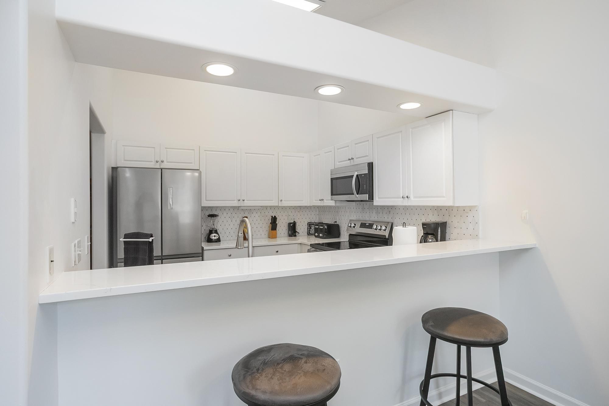 3911 Dodson Chapel Road, Unit 32 Hermitage, TN 37076 - Photo 8 of 25 a kitchen with stainless steel appliances granite countertop a sink and cabinets