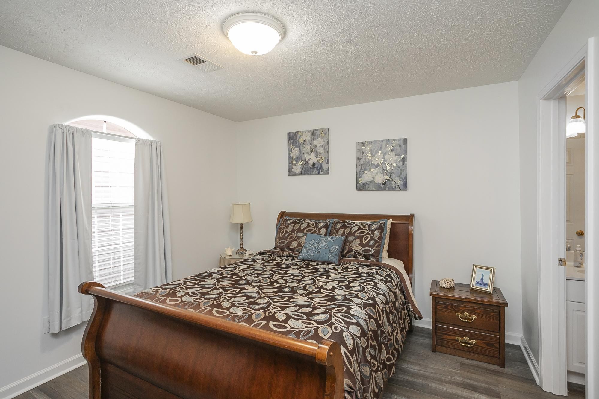 3911 Dodson Chapel Road, Unit 32 Hermitage, TN 37076 - Photo 9 of 25 a bedroom with a bed and wooden floor