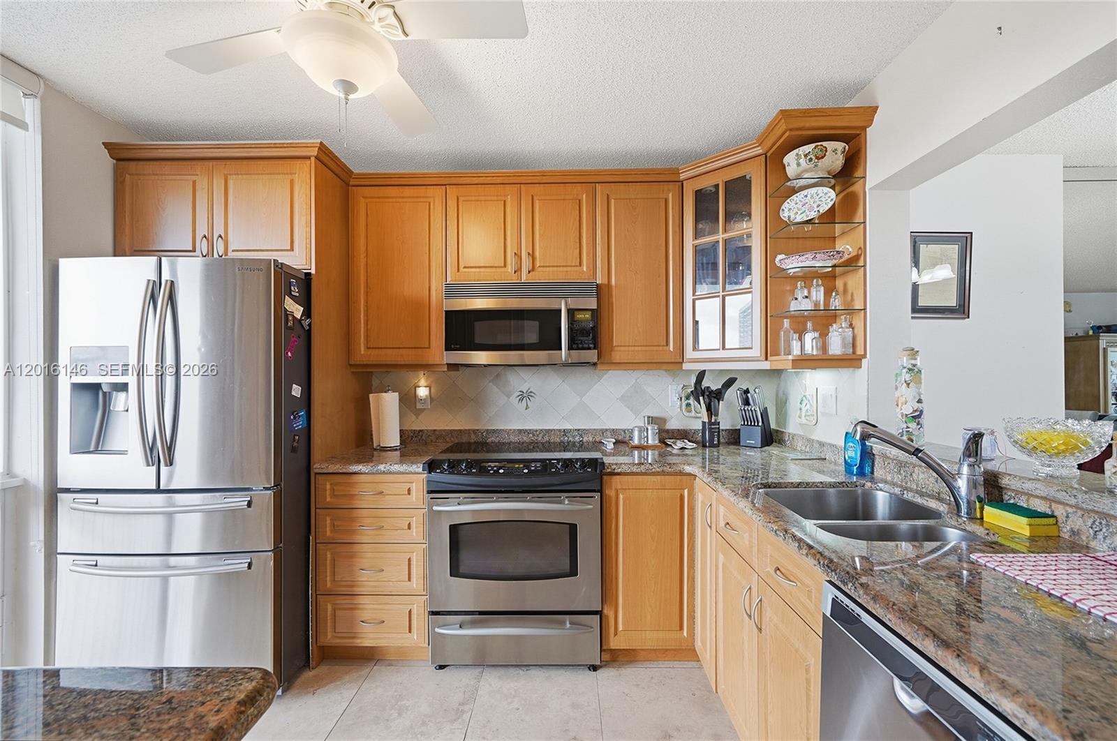 521 North Riverside Drive, Unit 606 Pompano Beach, FL 33062 - Photo 5 of 50 a kitchen with stainless steel appliances granite countertop a refrigerator stove and sink