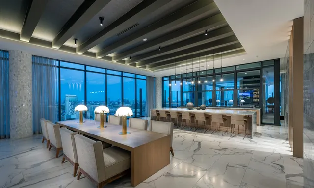 a living room with stainless steel appliances kitchen island granite countertop furniture and a fireplace