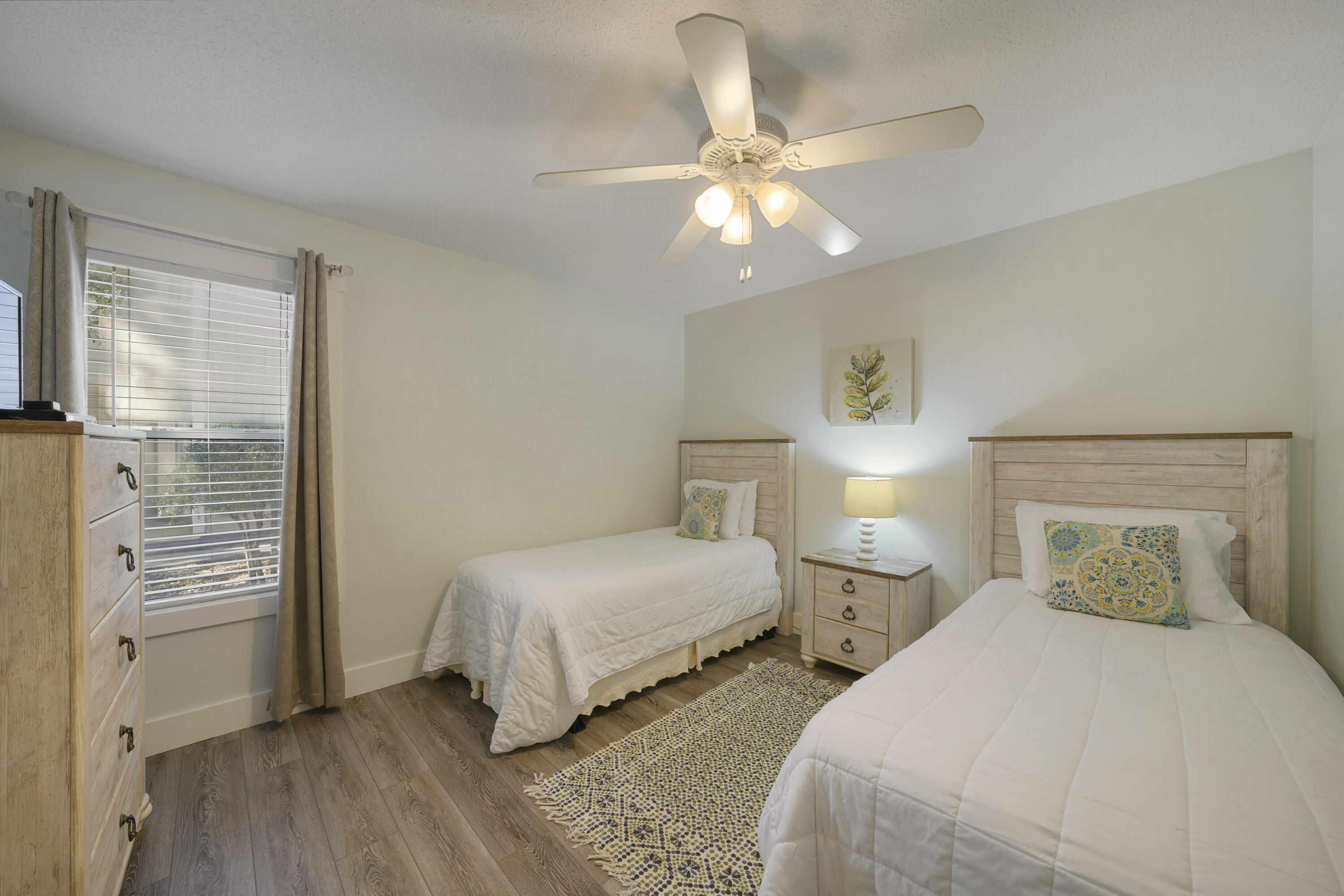9815 Highway 98, Unit 200 Miramar Beach, FL 32550 - Photo 18 of 54 a bedroom with two beds and a chandelier