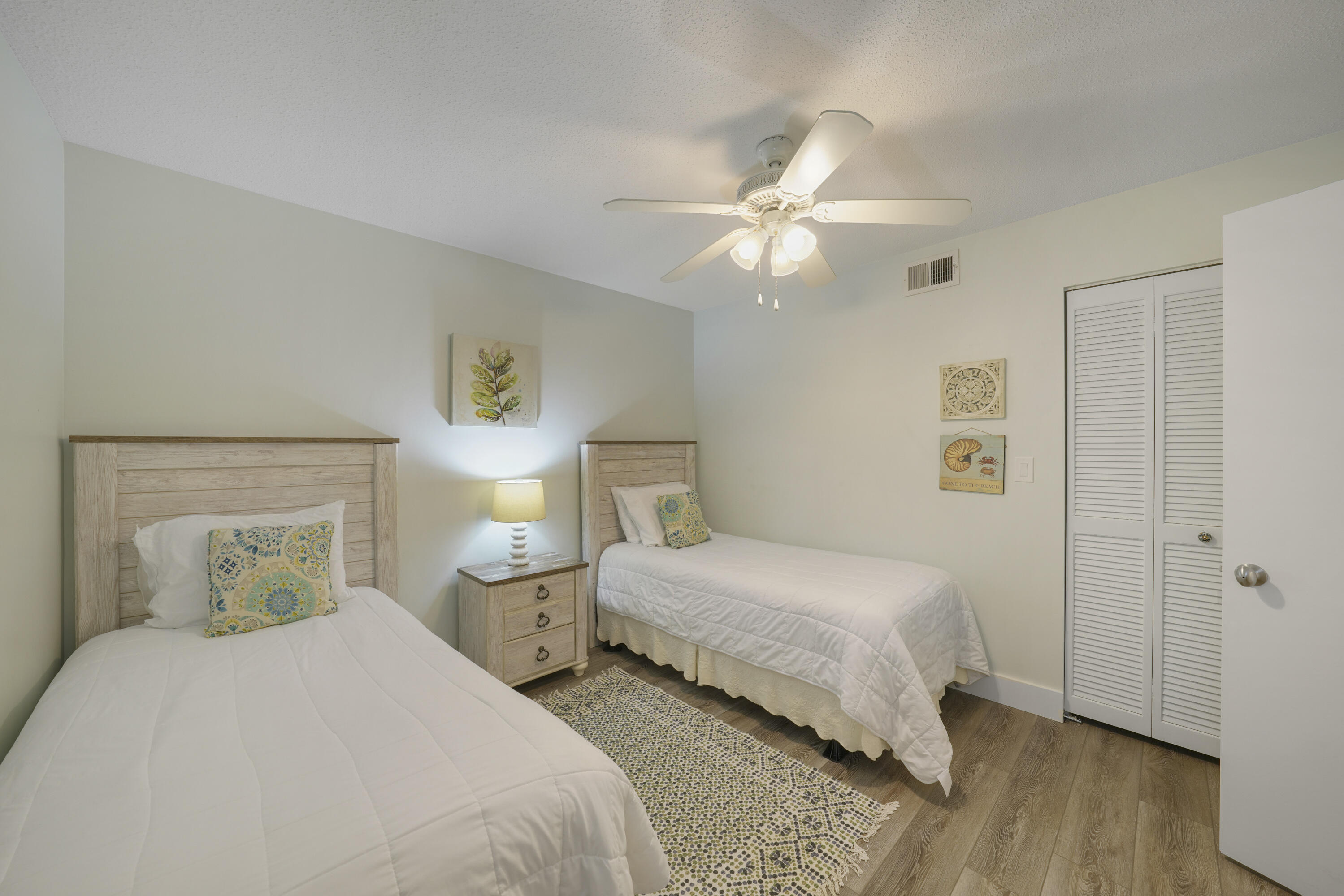 9815 Highway 98, Unit 200 Miramar Beach, FL 32550 - Photo 20 of 54 a bedroom with a bed and wooden floor