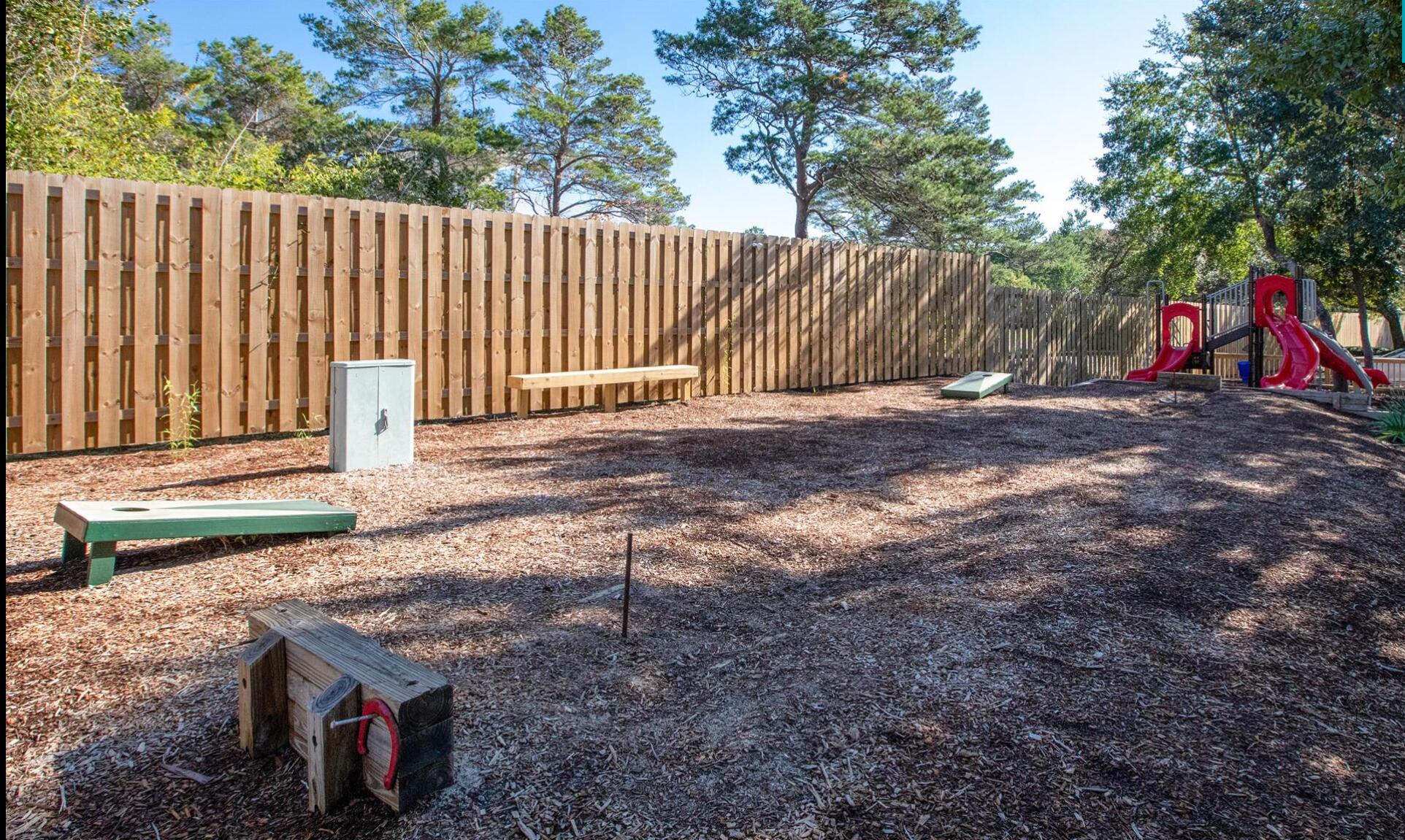 9815 Highway 98, Unit 200 Miramar Beach, FL 32550 - Photo 50 of 54 a backyard of a house with trees and outdoor seating