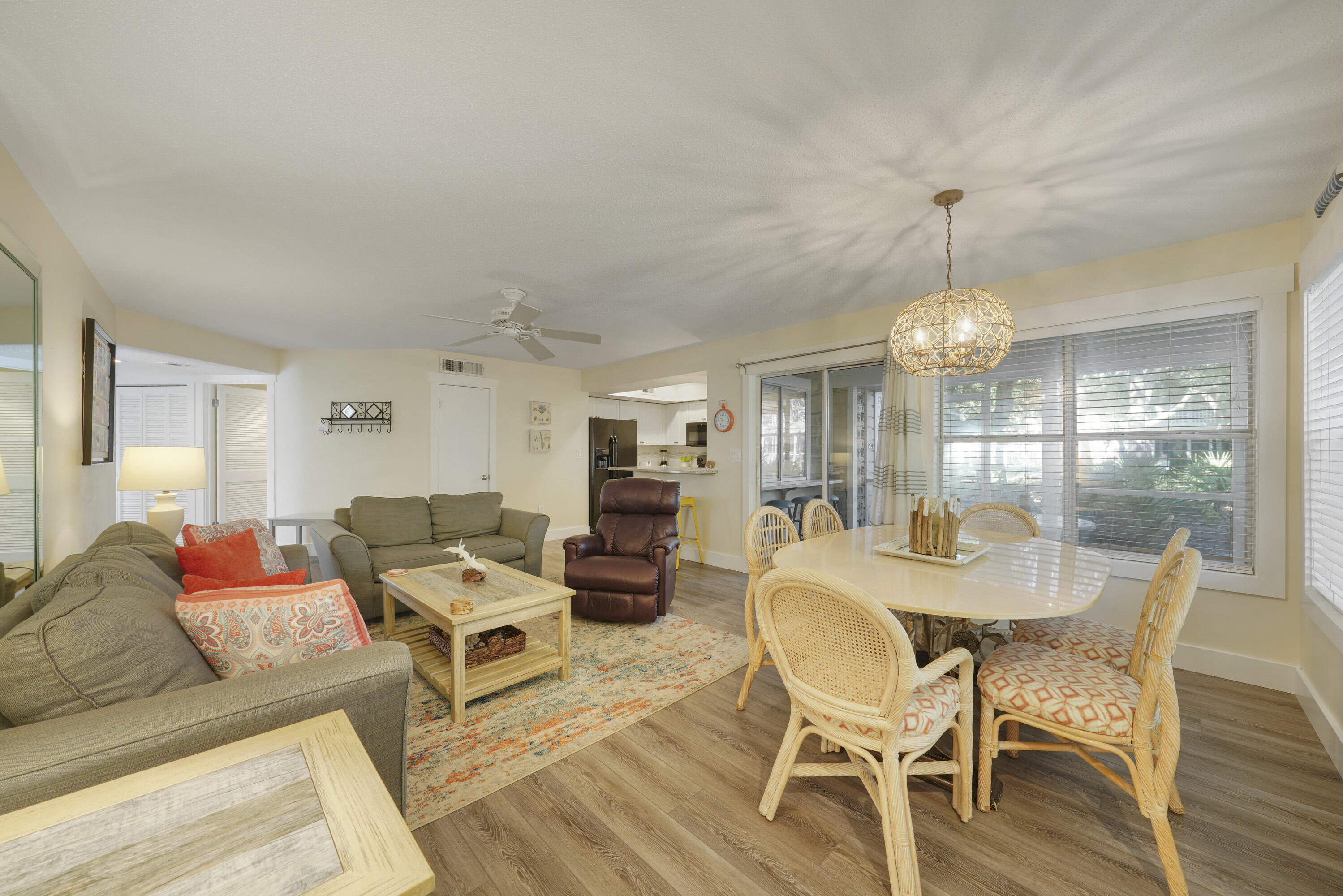 9815 Highway 98, Unit 200 Miramar Beach, FL 32550 - Photo 5 of 54 a living room with furniture a chandelier and a dining table