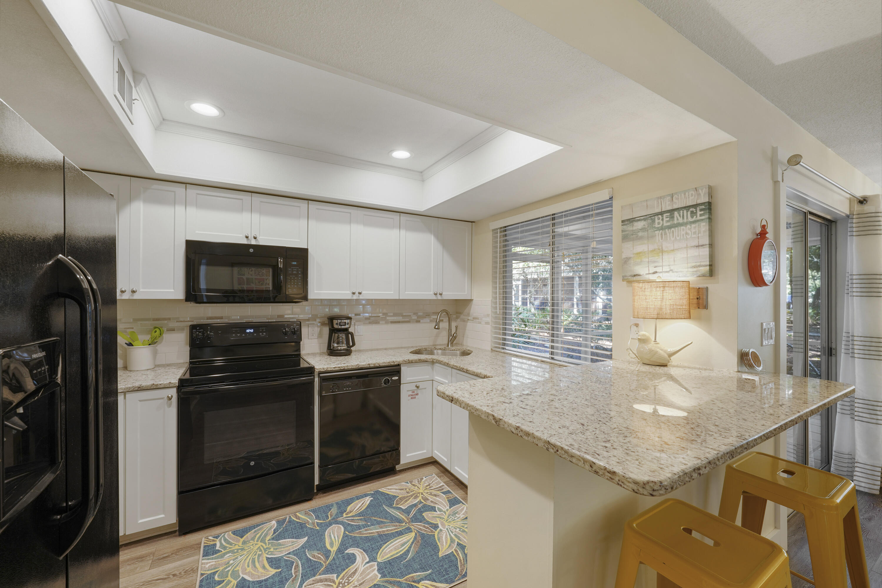 9815 Highway 98, Unit 200 Miramar Beach, FL 32550 - Photo 7 of 54 a kitchen with stainless steel appliances granite countertop a sink and a stove