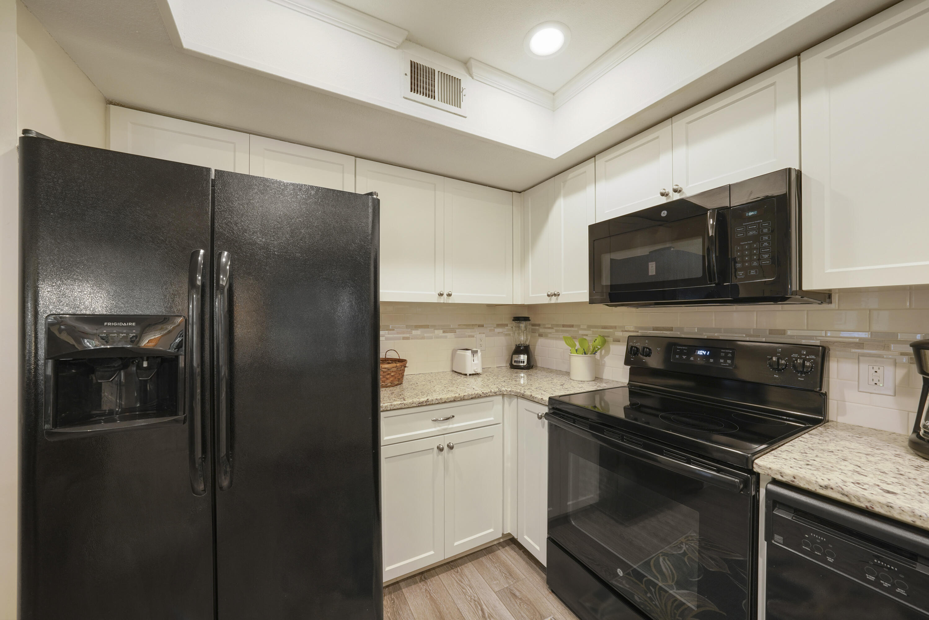 9815 Highway 98, Unit 200 Miramar Beach, FL 32550 - Photo 8 of 54 a kitchen with a refrigerator stove and microwave
