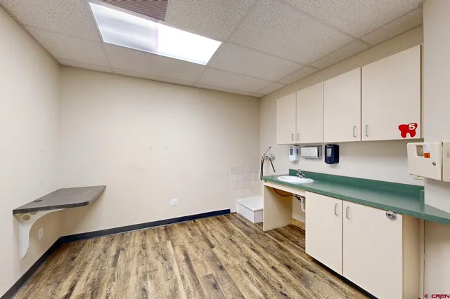 a kitchen with a sink and wooden cabinets