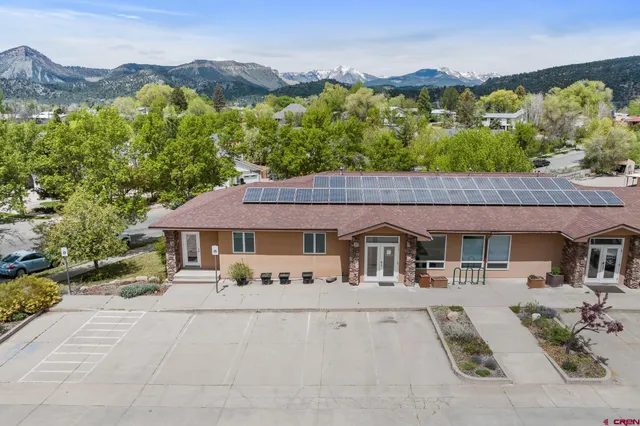 a view of house with a yard and furniture