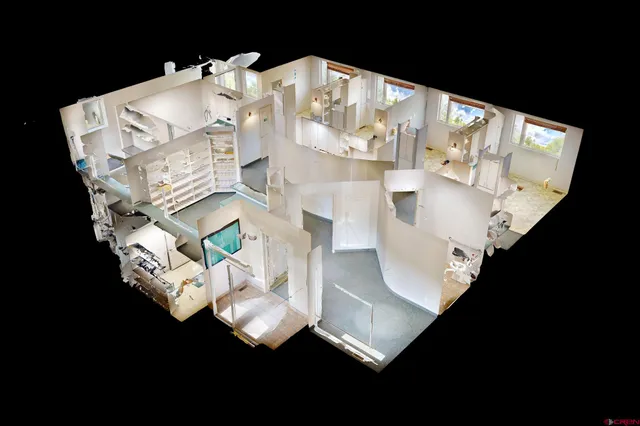 a white vase with flowers sitting on a table