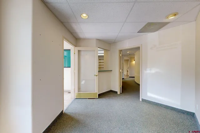 an empty room with a bathroom and a sink