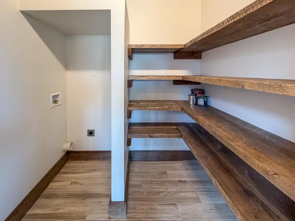 a view of a room with wooden floor