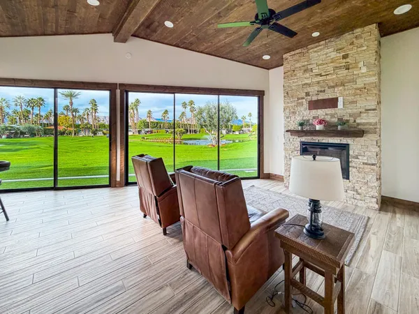 a view of a patio with a table chairs and a floor to ceiling window