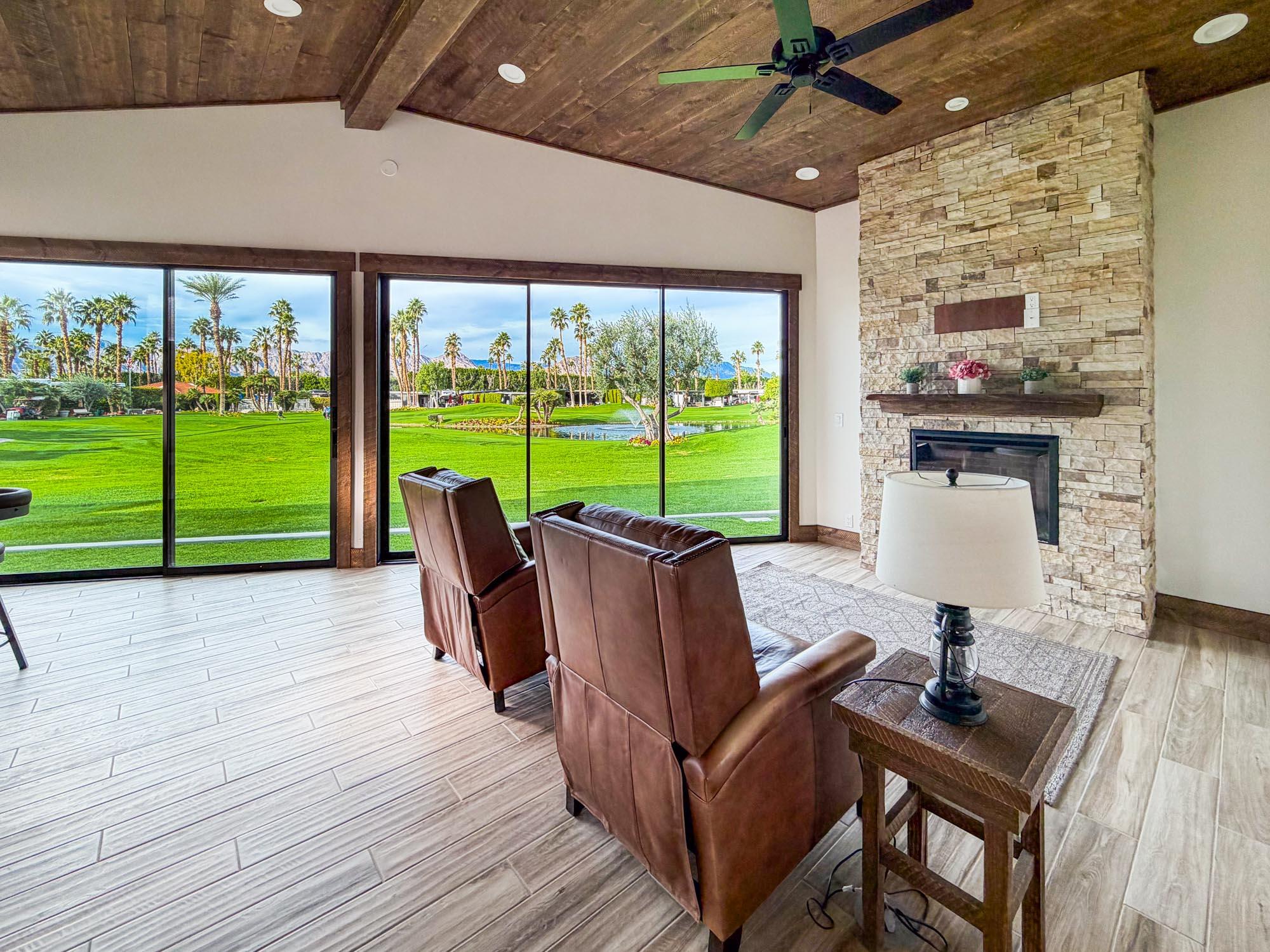 80394 Ave 48, Unit 189 Indio, CA 92201 - Photo 8 of 16 a view of a patio with a table chairs and a floor to ceiling window