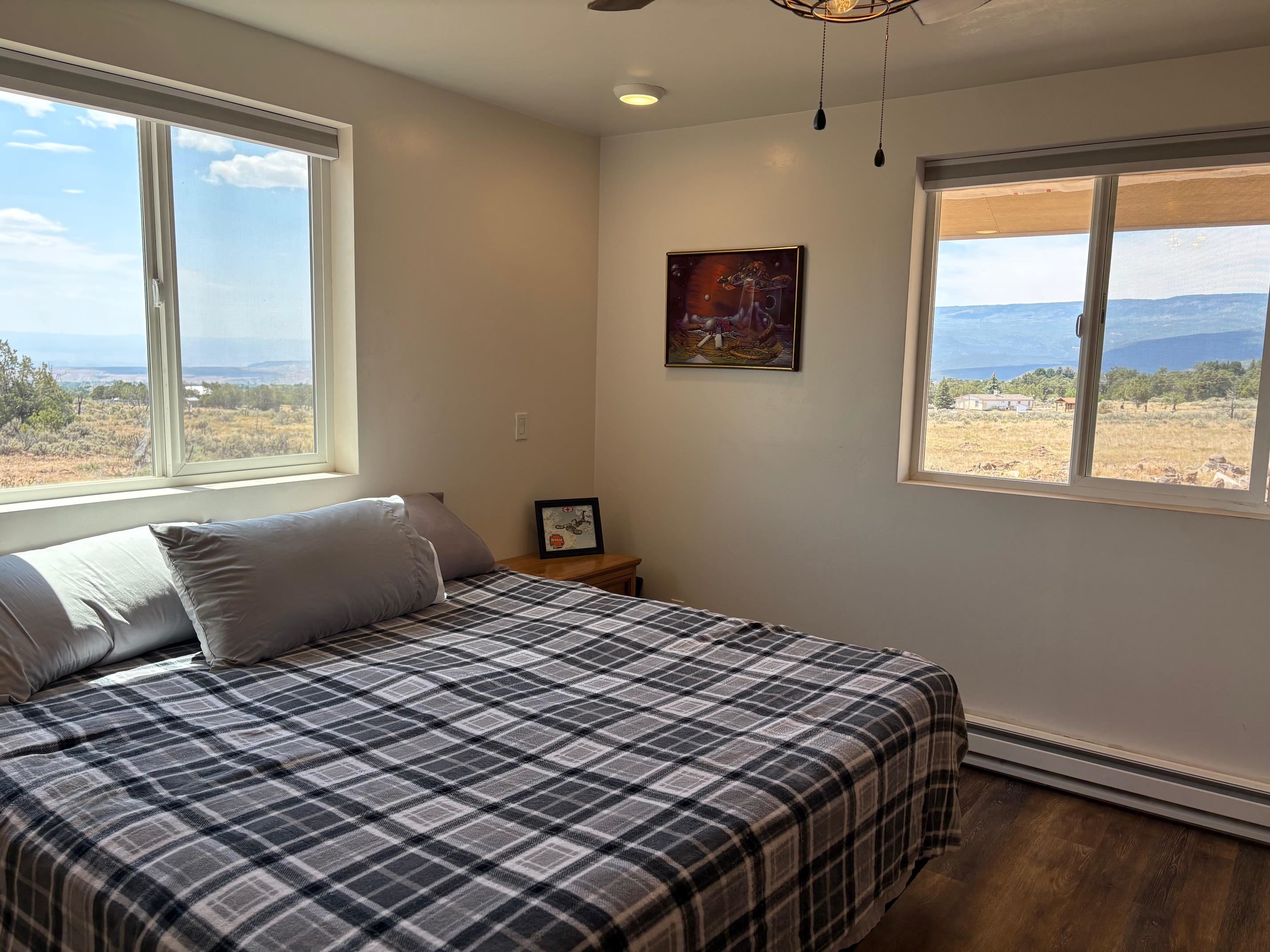 24500 Timothy Road Cedaredge, CO 81413 - Photo 11 of 33 a bedroom with a bed and a window