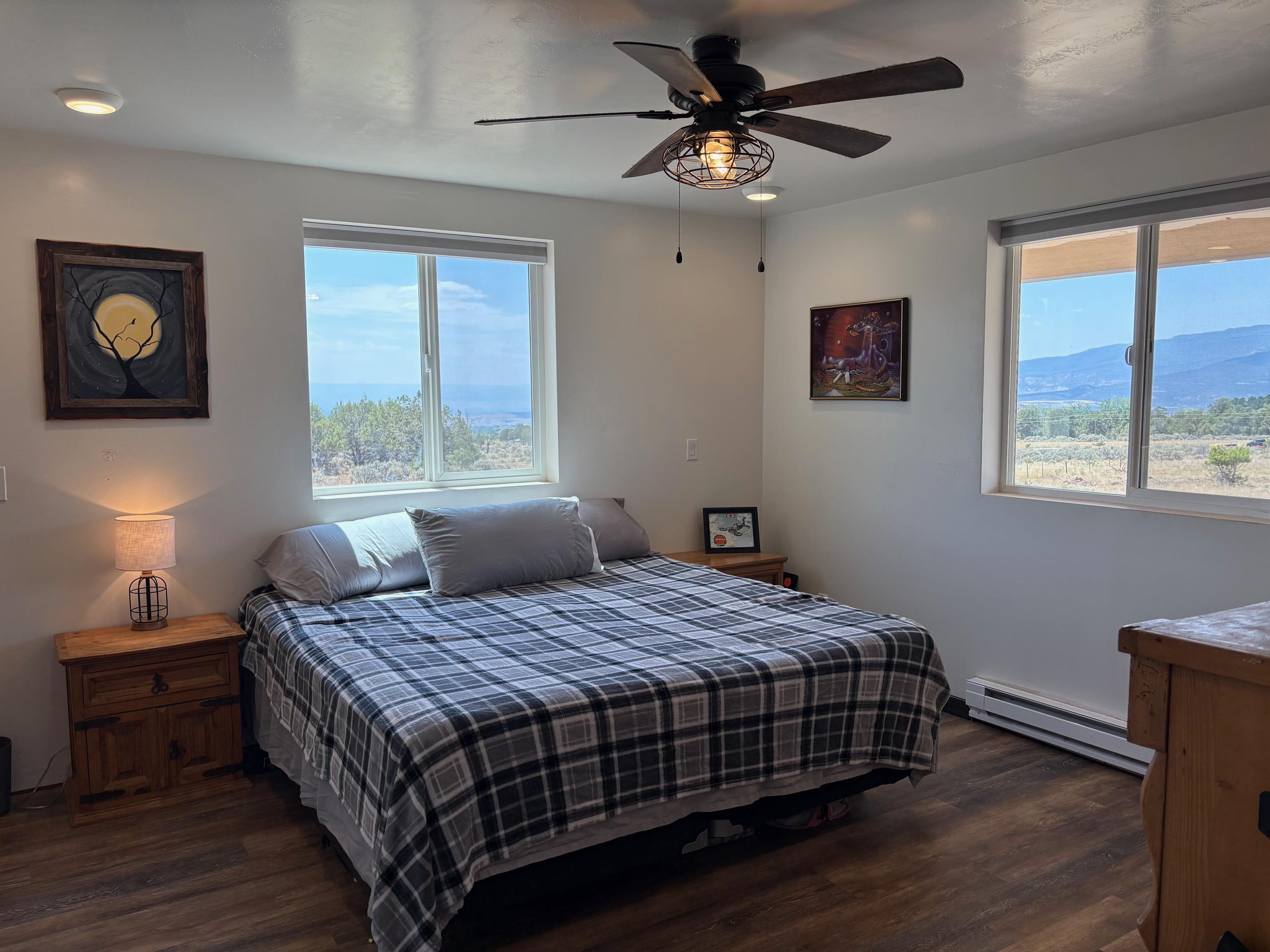 24500 Timothy Road Cedaredge, CO 81413 - Photo 12 of 33 a bedroom with a bed and wooden floor