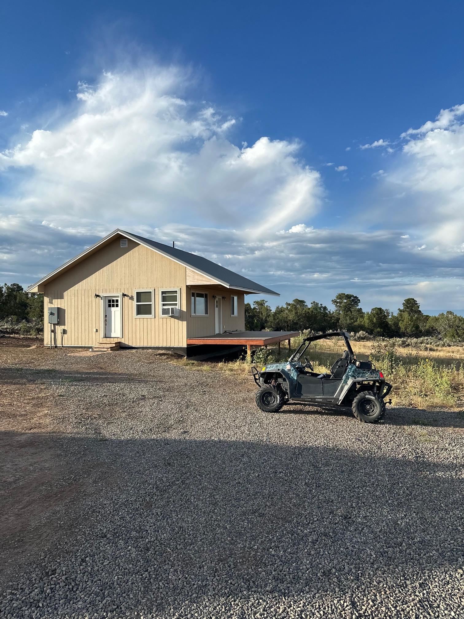 24500 Timothy Road Cedaredge, CO 81413 - Photo 27 of 33 a view of a house with a car parked in front of a house