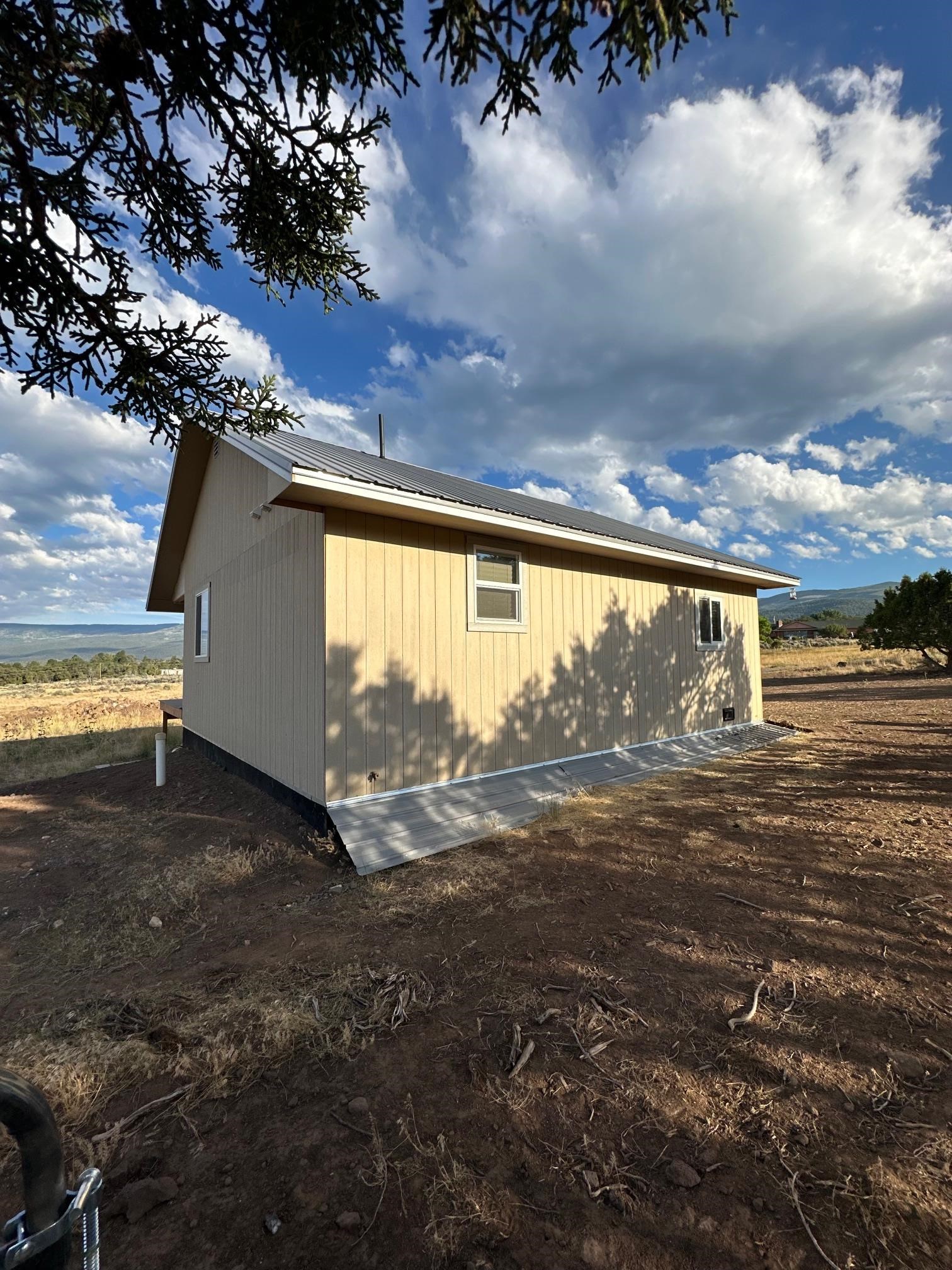 24500 Timothy Road Cedaredge, CO 81413 - Photo 29 of 33 a view of a house with a yard