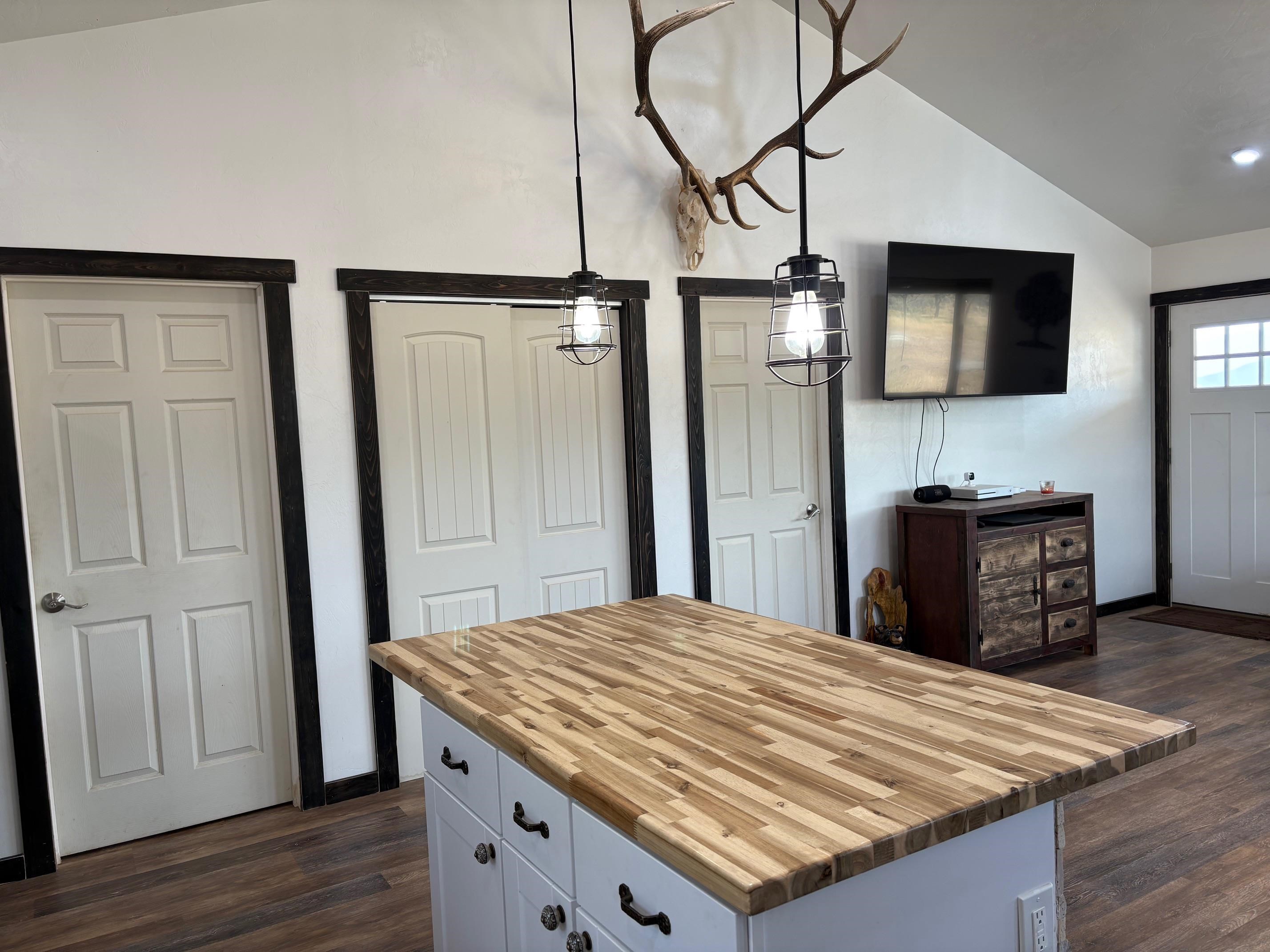 24500 Timothy Road Cedaredge, CO 81413 - Photo 5 of 33 a room view with a wooden floor and a hallway