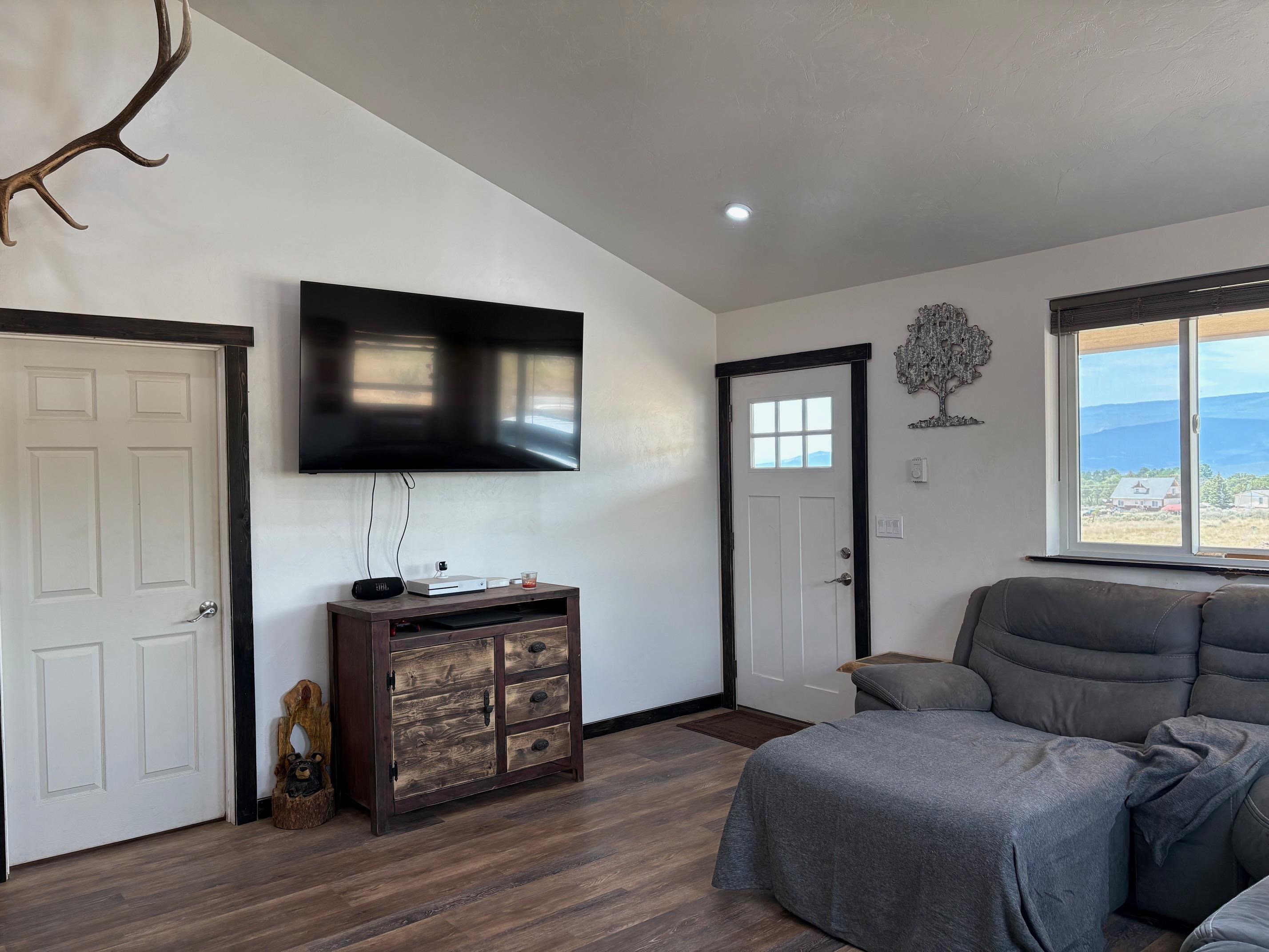 24500 Timothy Road Cedaredge, CO 81413 - Photo 9 of 33 a living room with furniture and a flat screen tv