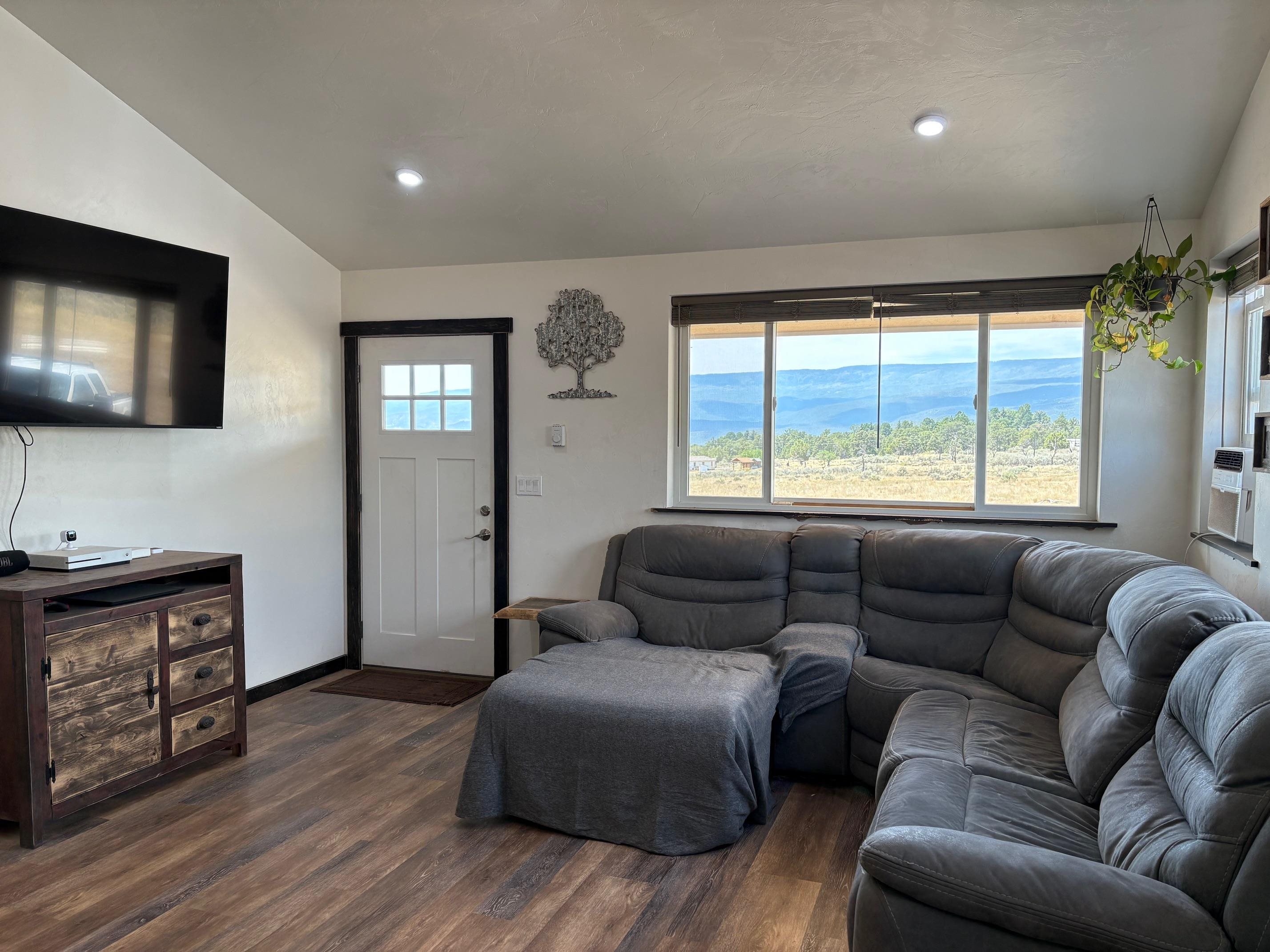 24500 Timothy Road Cedaredge, CO 81413 - Photo 10 of 33 a living room with furniture and a flat screen tv