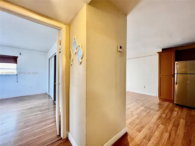 a view of a hallway with wooden floor