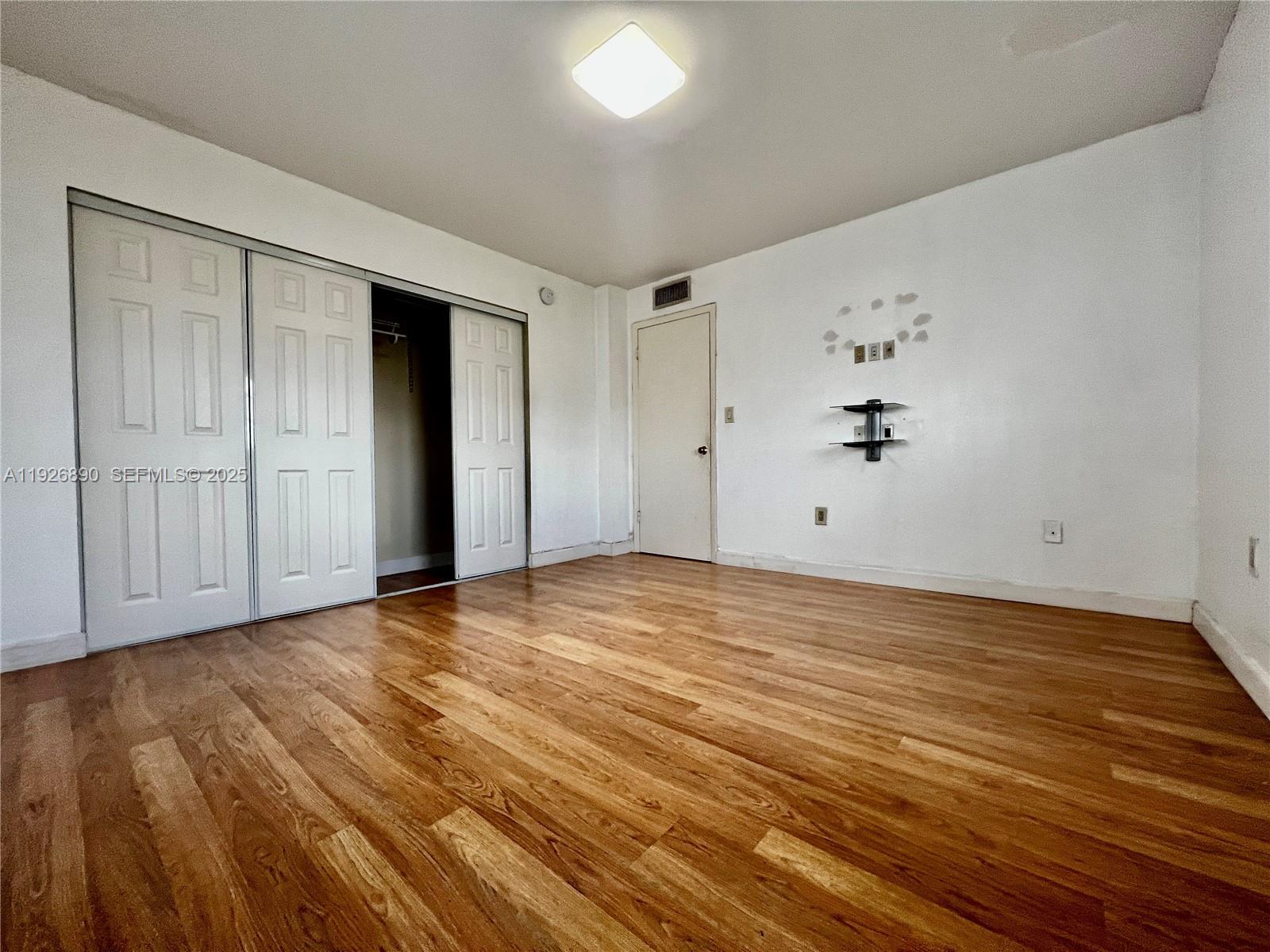 424 Southwest 7th Street, Unit 402 Miami, FL 33130 - Photo 8 of 11 wooden floor in an empty room