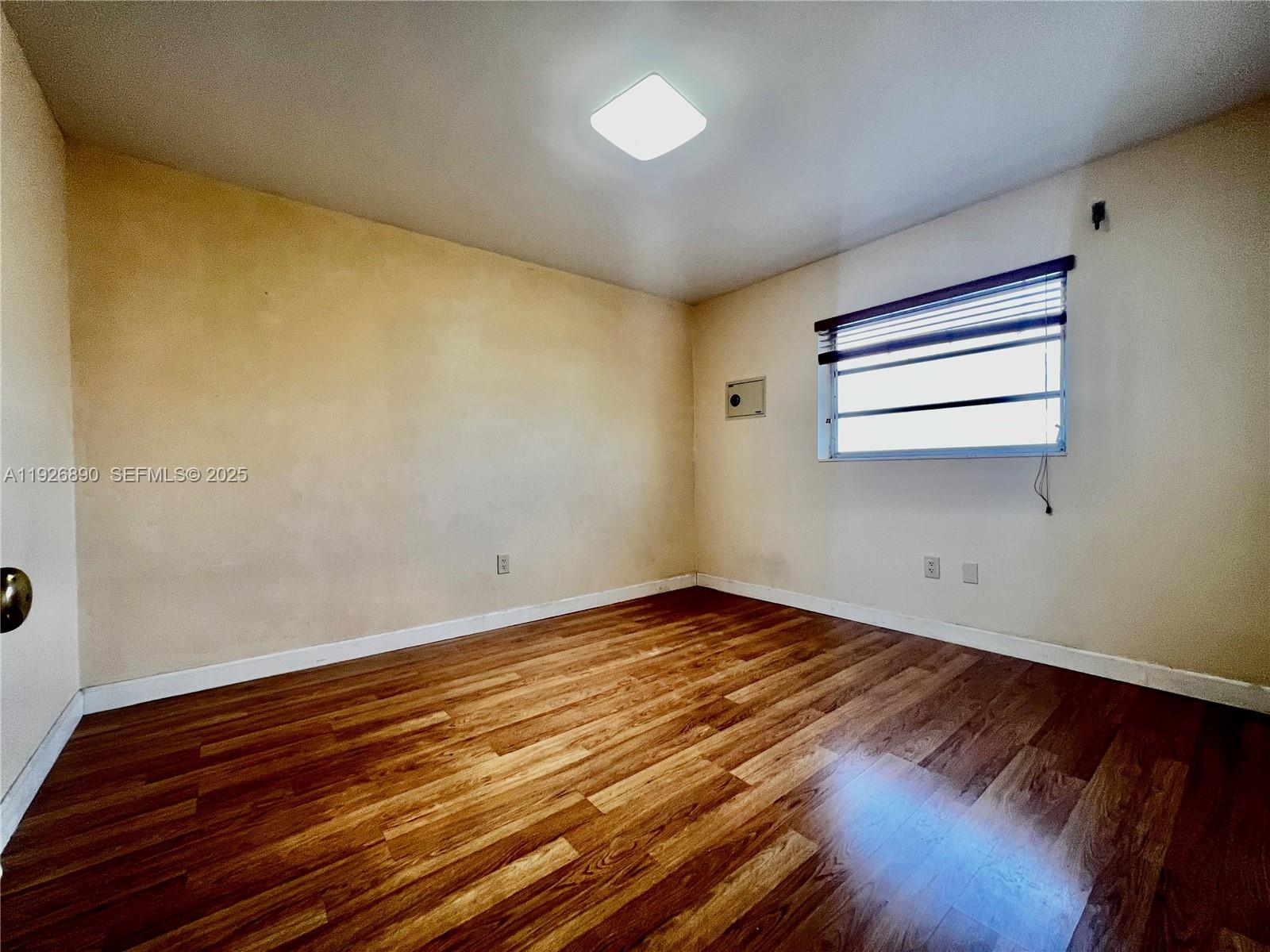 424 Southwest 7th Street, Unit 402 Miami, FL 33130 - Photo 10 of 11 a view of empty room with wooden floor