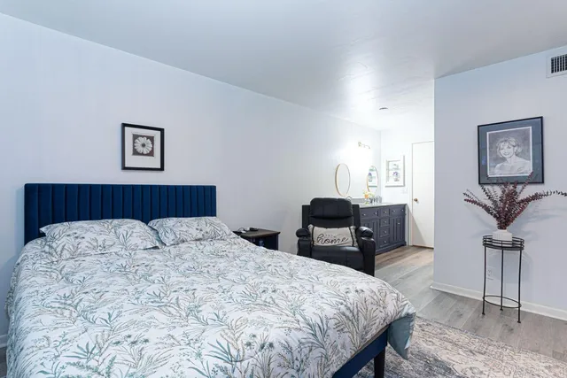 a bedroom with a bed and a table in it